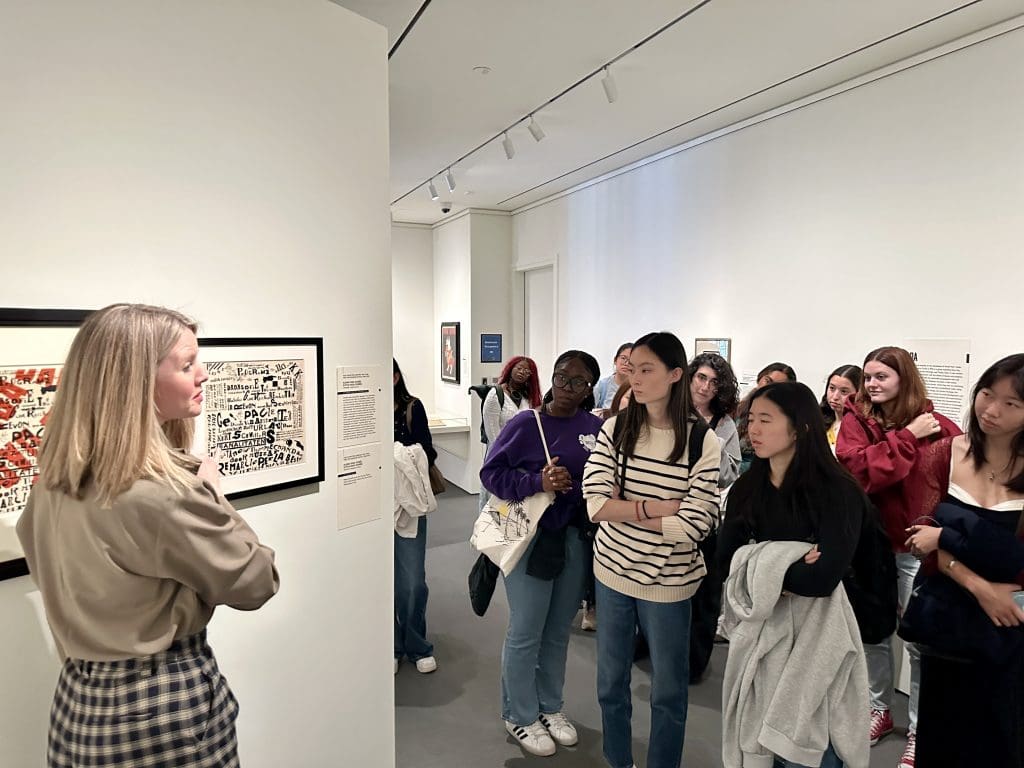 students listening to curator caitlin Berry at the Irene and Richard Frary Gallery