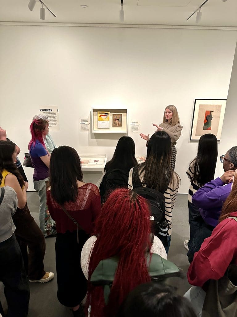 students listening to curator caitlin Berry at the Irene and Richard Frary Gallery