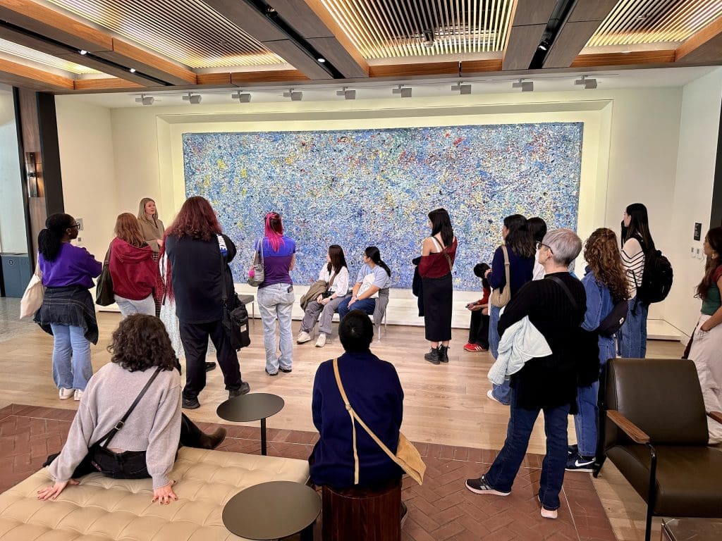 students listening to curator caitlin Berry at the Irene and Richard Frary Gallery