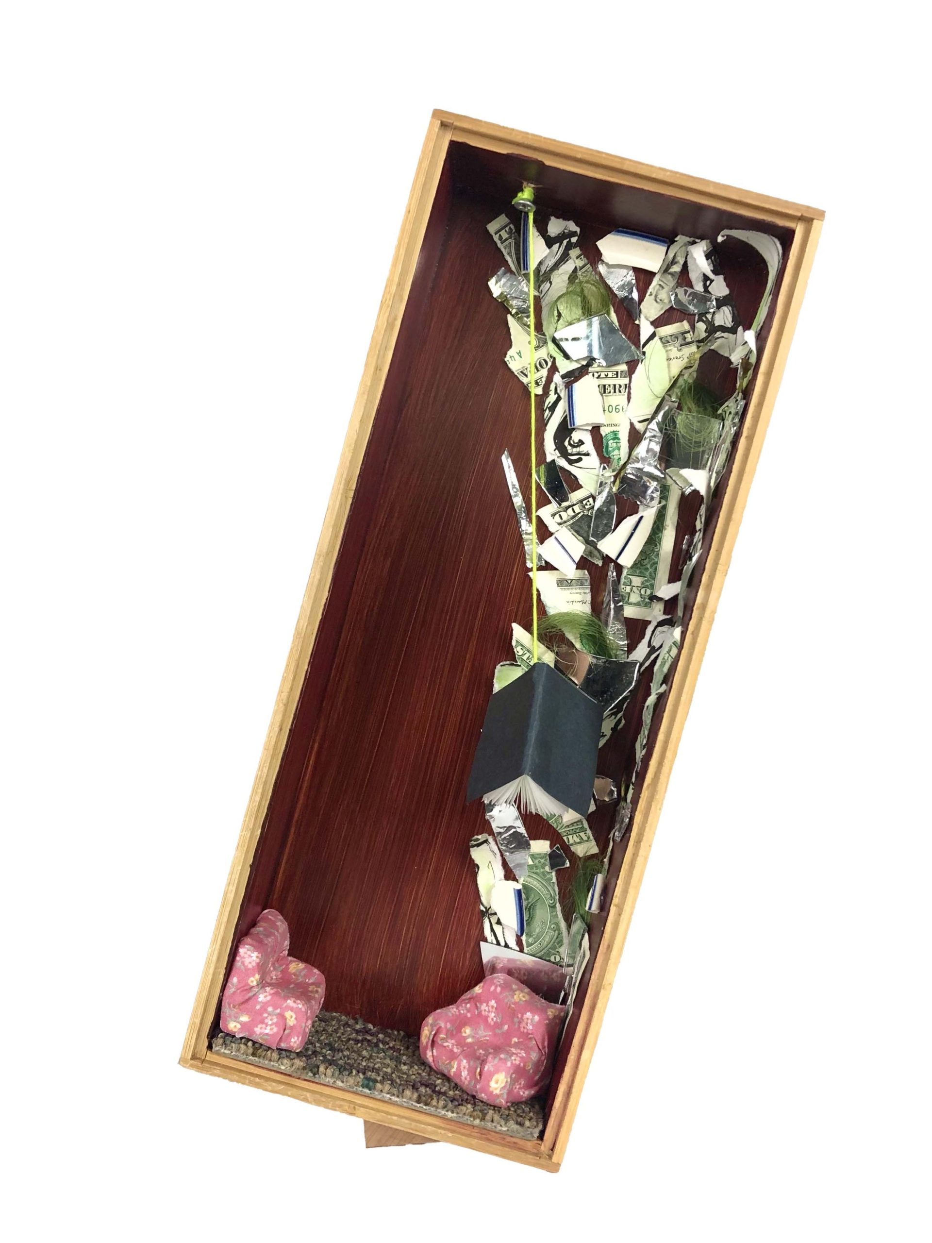 wooden box with small pink couches and cut up money