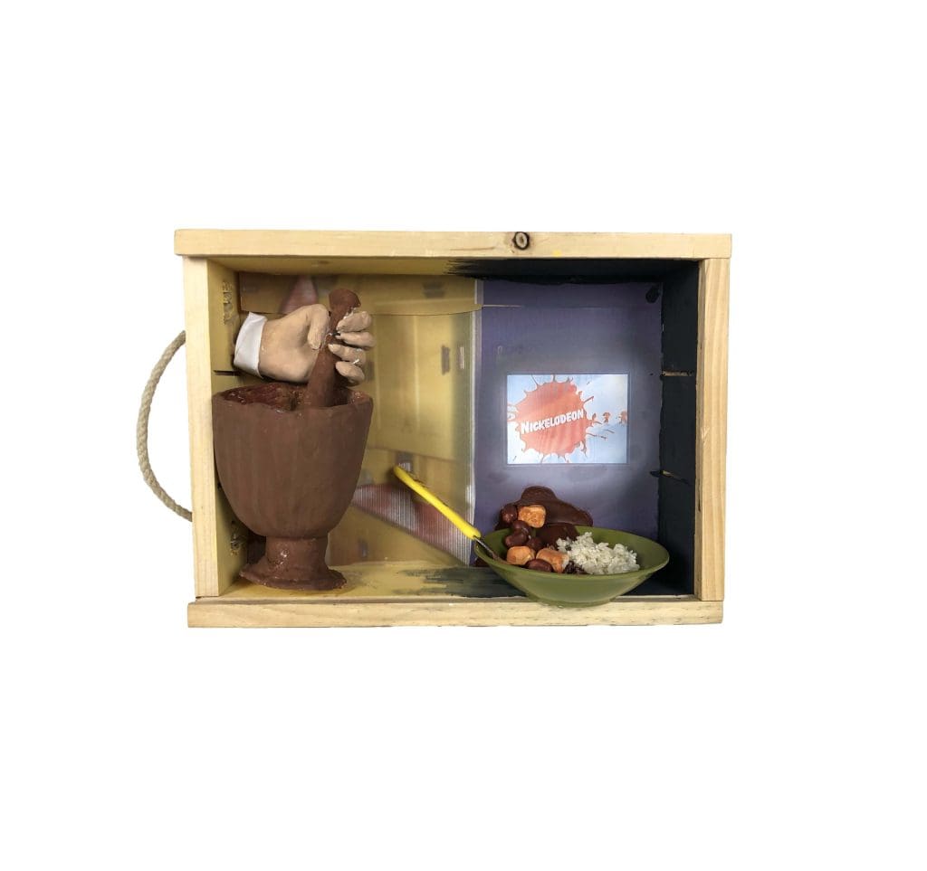 wooden box with a hand mixing a spoon in a bowl and nickelodeon sign