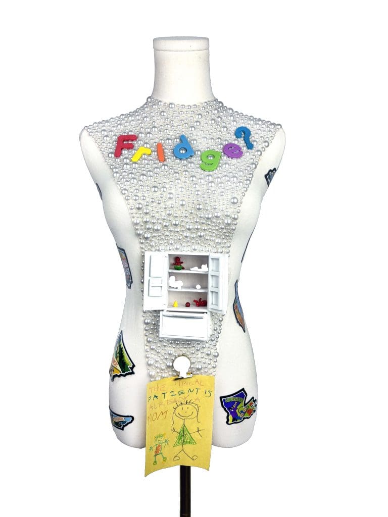 dress form with the word fridge? across its chest and a toy fridge attached to its belly