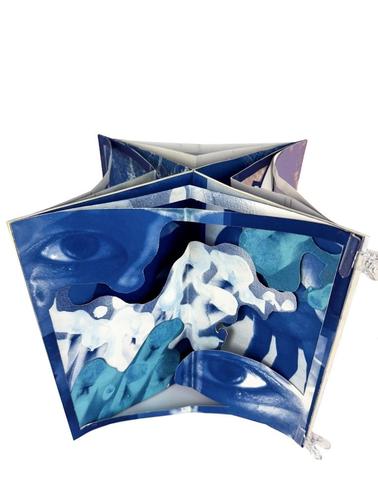 folded book with images printed on top with the cyanotype process