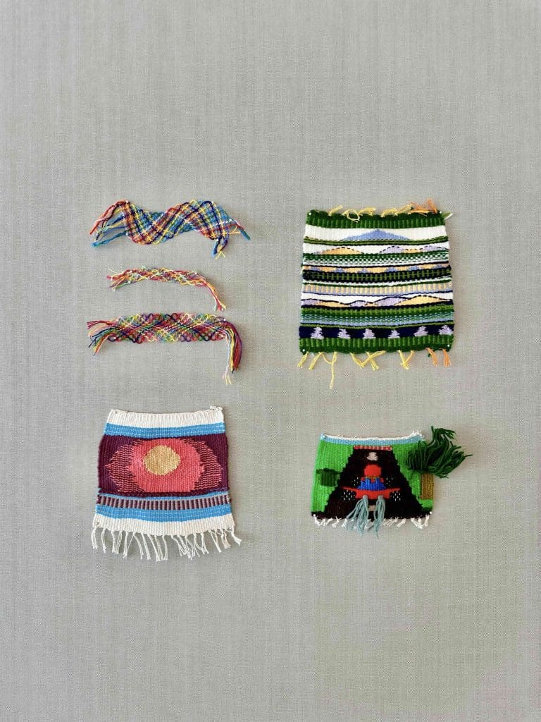 four different fiber artworks hung on wall