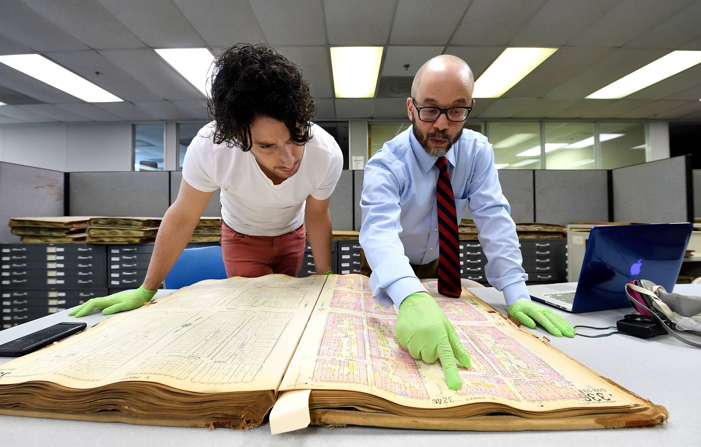 student and Larry Jackson examining large, old book