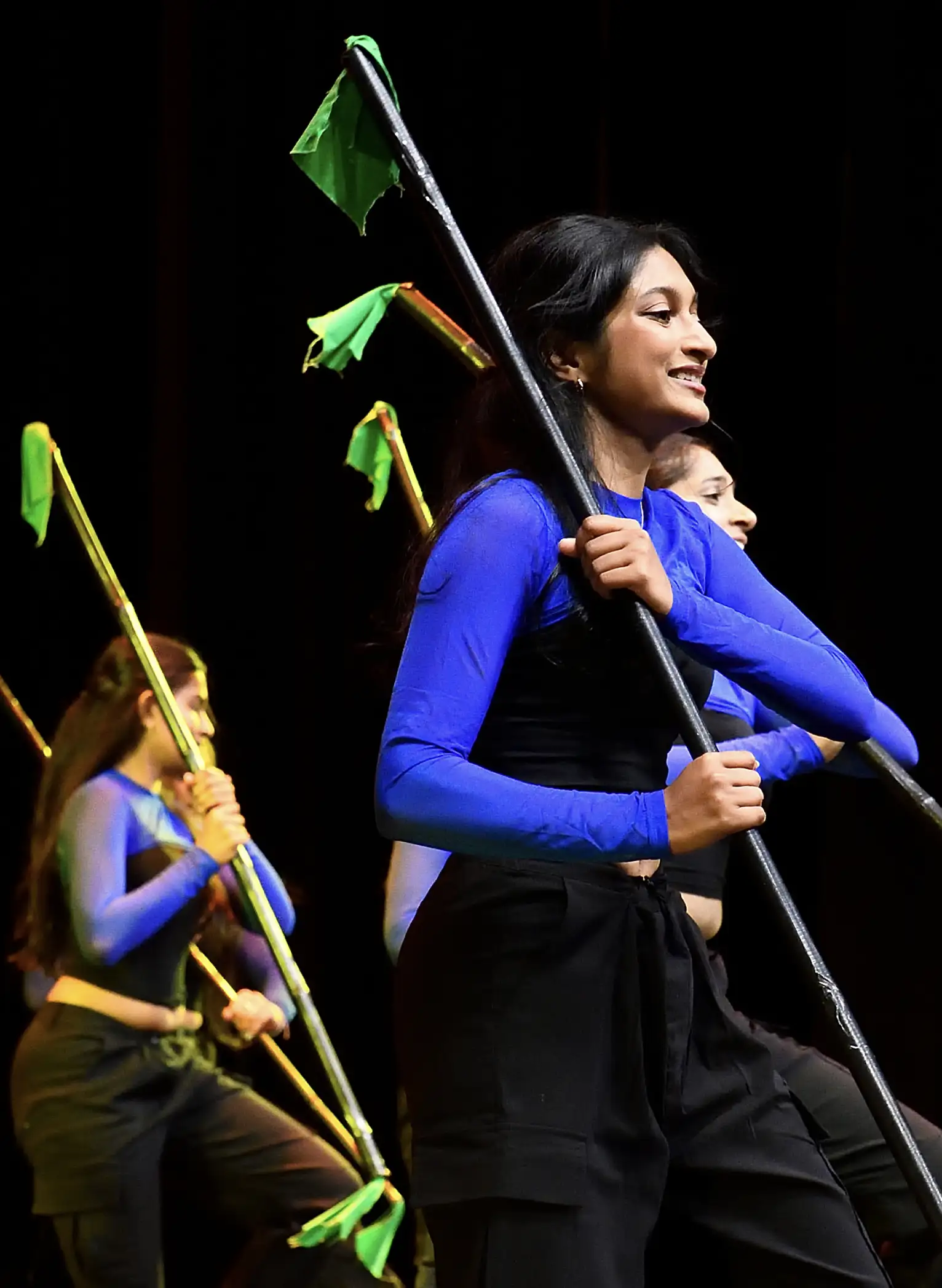 A student dance group performing on stage.