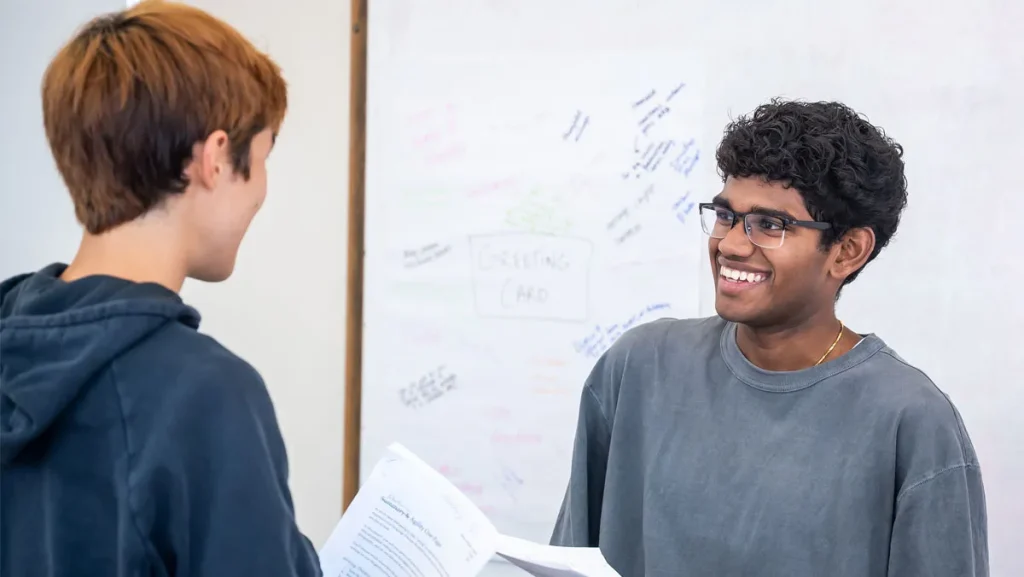 two students in discussion during class