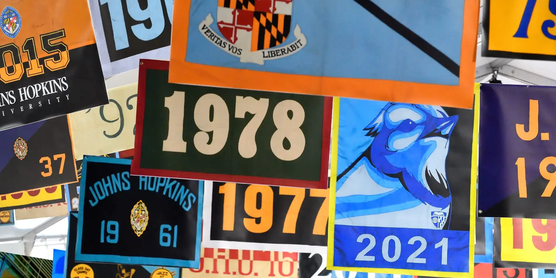 A variety of class flags from various years hung together.