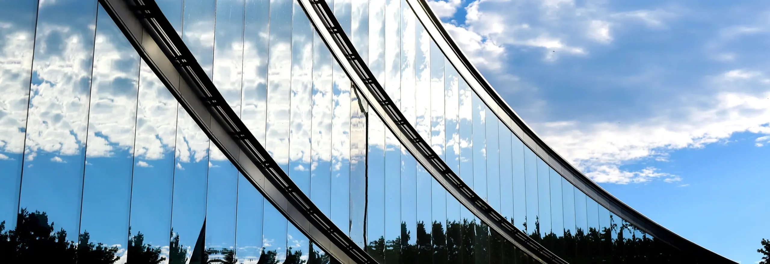 A view of the sky reflected in the exterior glass facade of the Bascom Undergraduate Teaching Laboratory.