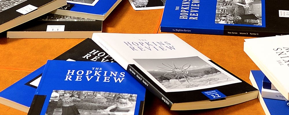 various editions of Hopkins Review laying on table